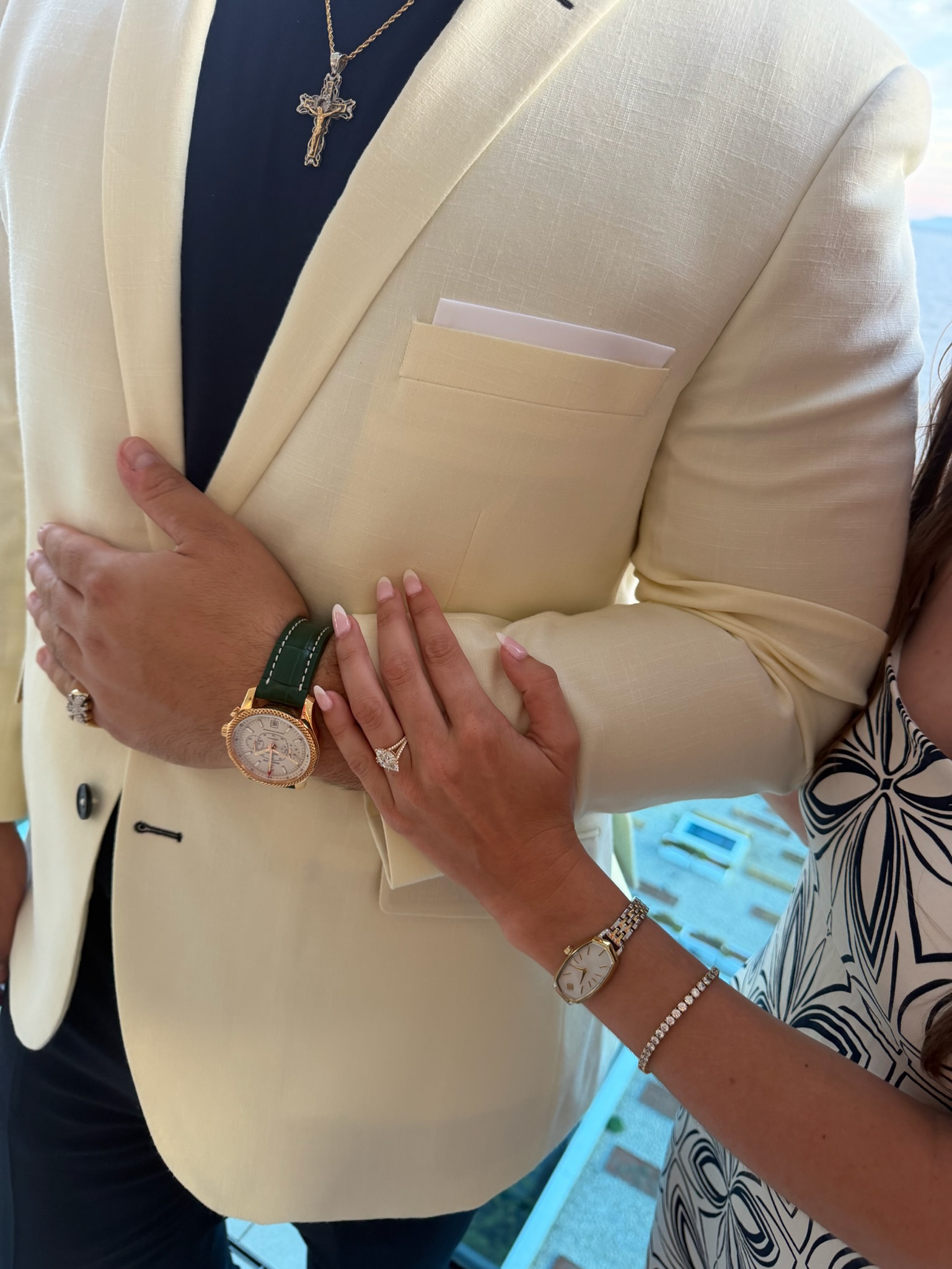 A close-up of Tatum's engagement ring as she holds Zachary's arm